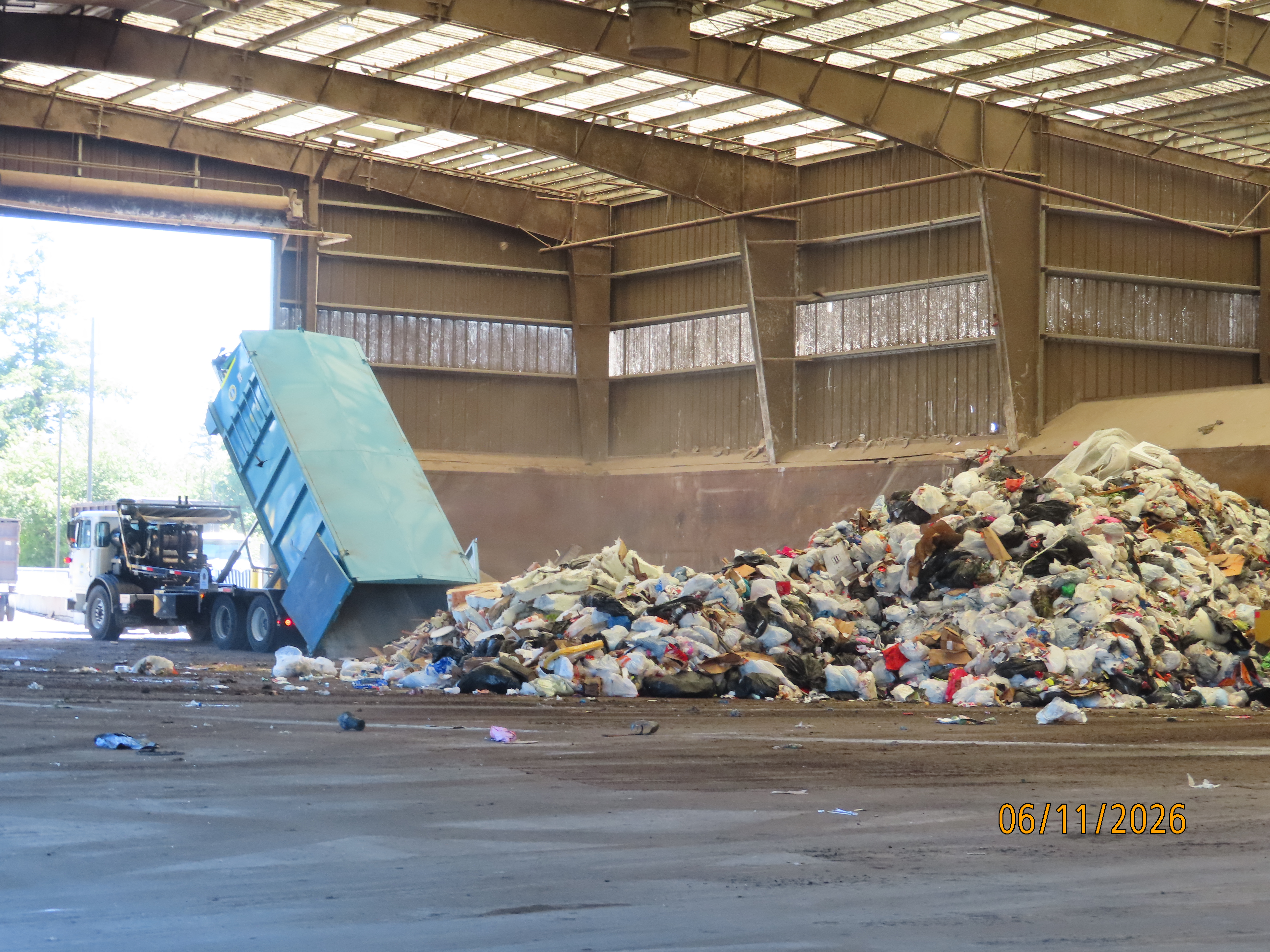 Garbage truck dumping garbage at the dump.