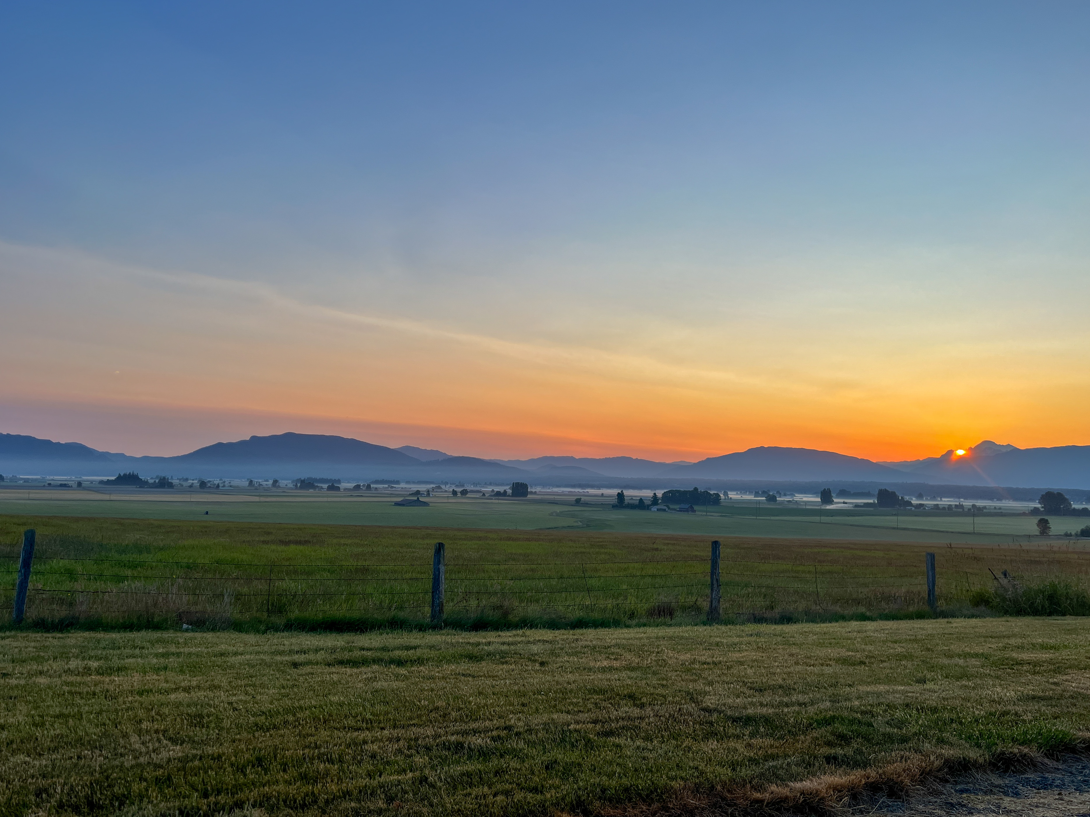 Sunset over agricultural field in Skagit Valley.