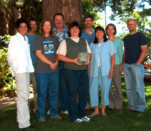 A group of people holding an award