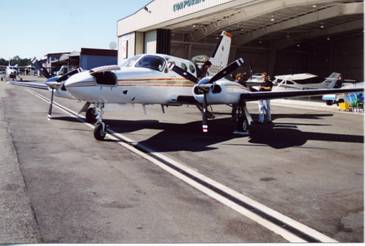 A plane in front of a hanger